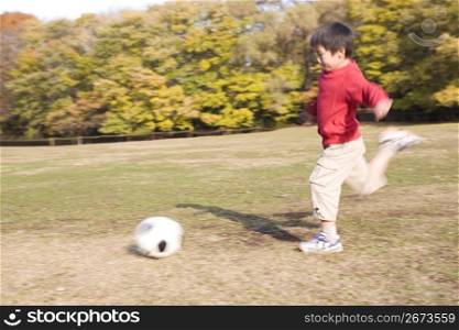 Japanese boy playing soccer