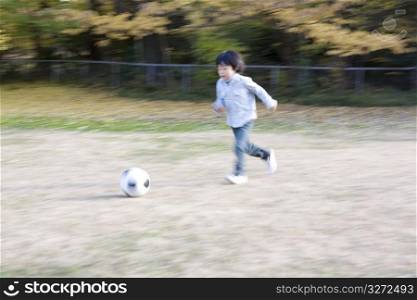 Japanese boy playing soccer