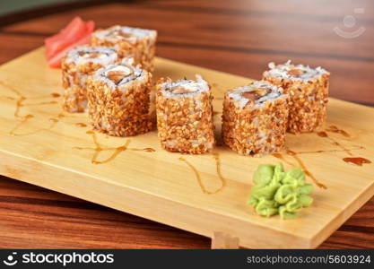 Japanese cuisine - sesame sushi rolls with syrup