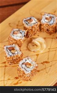 Japanese cuisine - sesame sushi rolls with syrup. sesame sushi rolls