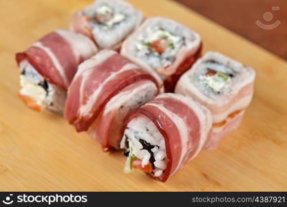 Japanese cuisine - sushi roll with bacon