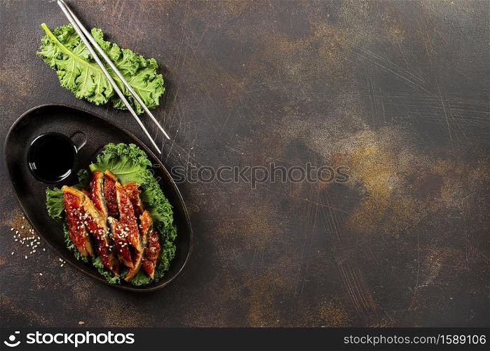 Japanese eel grilled or Unagi ibaraki set on plate, eel with sesame and unagi sauce