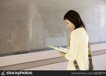 Japanese female student standing in front of board
