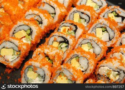 japanese food, close-up of sushi rolls on buffet line