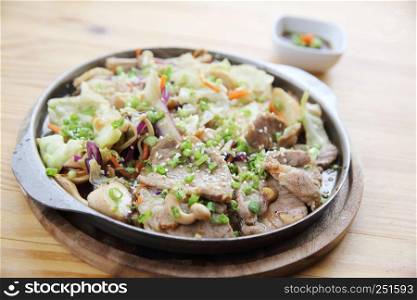 Japanese food pork with ginger on pan in wood background