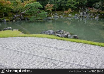 Japanese garden. Japanese garden with lake and stone field