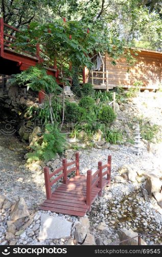 Japanese garden with a small bridge over a small courtyard