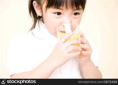 Japanese girl drinking orange juice