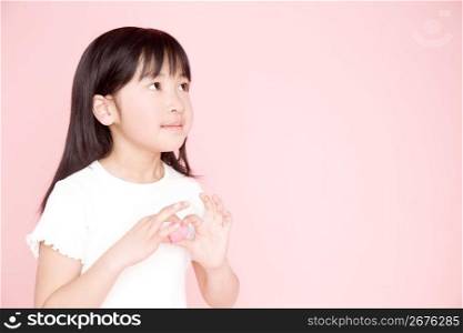 Japanese girl having a heart-shaped ornament