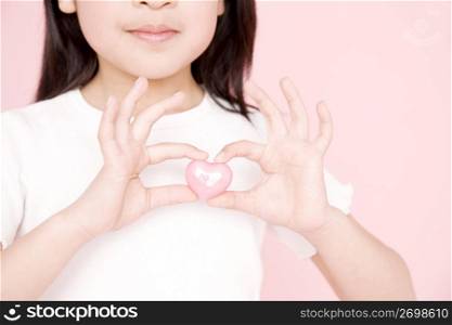 Japanese girl having a heart shaped ornament