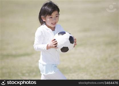 Japanese girl having a soccer ball