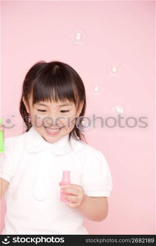 Japanese girl playing with soap bubble