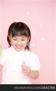 Japanese girl playing with soap bubble
