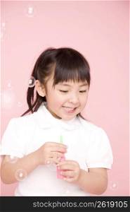 Japanese girl playing with soap bubbles