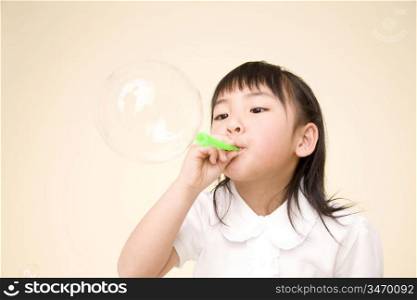 Japanese girl playing with soap bubbles