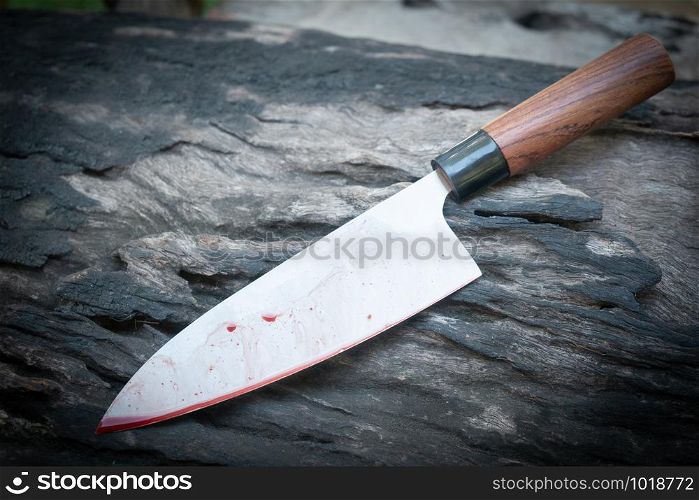 Japanese kitchen deba knife bloody on wood background