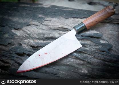 Japanese kitchen deba knife bloody on wood background
