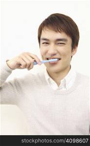 Japanese man brushing his teeth