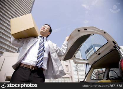 Japanese office worker carrying corrugated cardboard