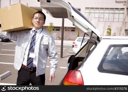 Japanese office worker carrying corrugated cardboard