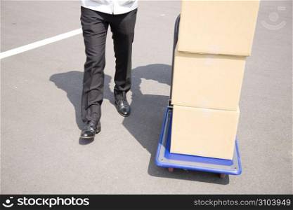 Japanese office worker carrying corrugated cardboards