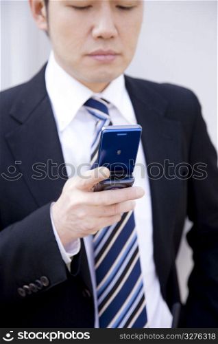 Japanese office worker checking a cellphone
