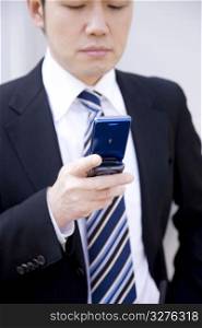 Japanese office worker checking a cellphone