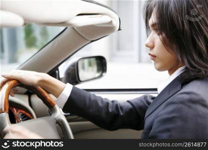 Japanese office worker driving a car