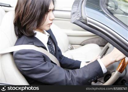 Japanese office worker driving a car