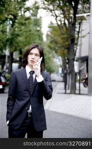 Japanese office worker talking with cell phone