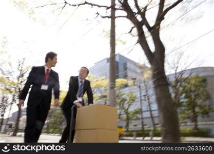 Japanese office workers carrying corrugated cardboards