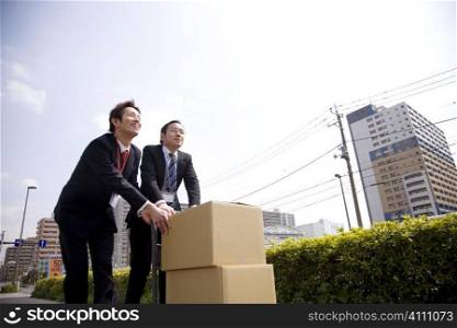 Japanese office workers carrying corrugated cardboards