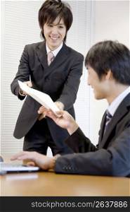 Japanese office workers having brief meeting