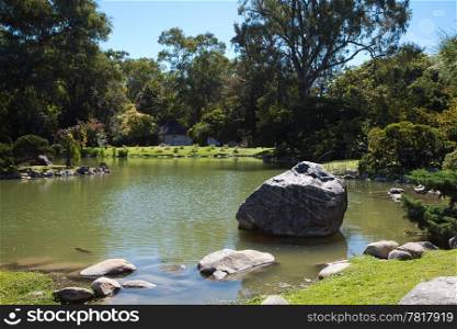 Japanese pond with carps and stones