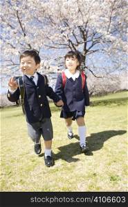 Japanese schoolchildren walking through the park