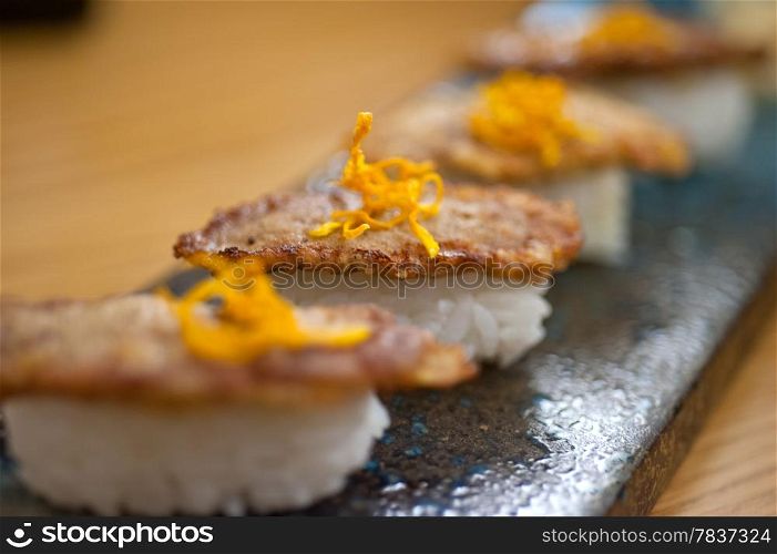 Japanese style sushi fried goose liver macro closeup