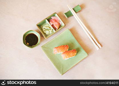 japanese sushi on the green plate and chopsticks