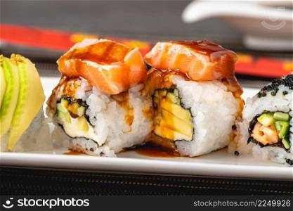 Japanese sushi set. Sushi Roll with maki and tuna, salmon, shrimp, crab and avocado.