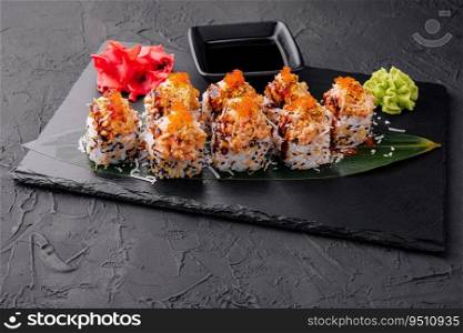 Japanese sushi volcano roll with eel on top and sesame inside