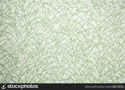 Japanese Washi tissue with white grass pattern against green mulberry paper
