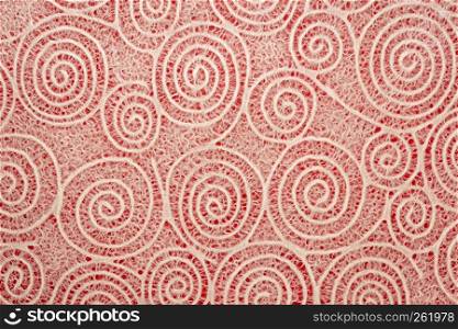Japanese Washi tissue with white Uzumaki pattern spirals against red mulberry paper