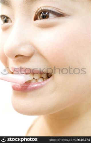 Japanese woman brushing her teeth