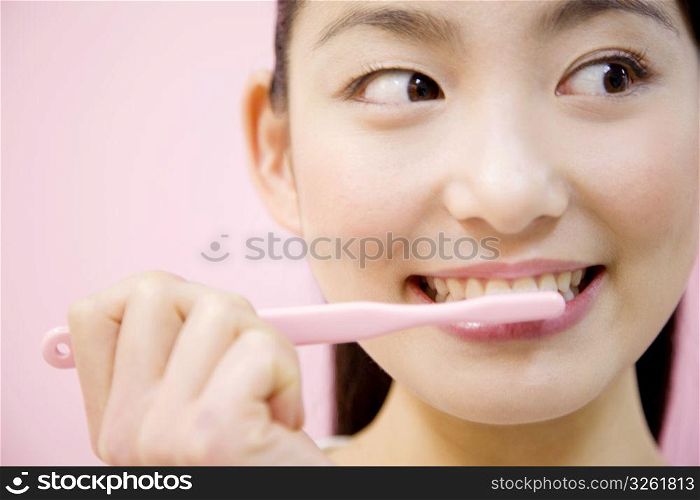Japanese woman brushing her teeth