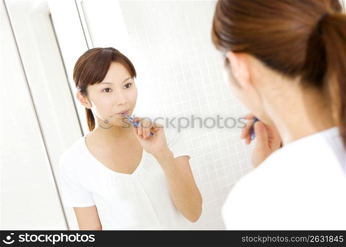 Japanese woman brushing teeth