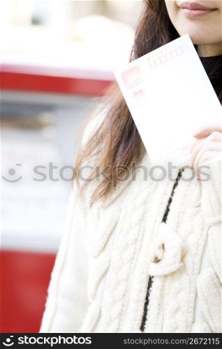 Japanese woman having a postcard