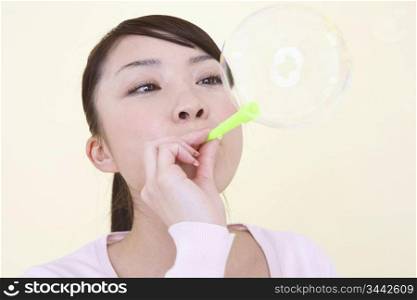 Japanese woman playing with soap bubble