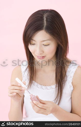 Japanese woman polishing her nails