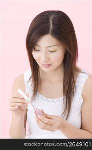 Japanese woman polishing her nails
