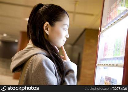Japanese woman standing in front of vender machine