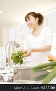 Japanese woman washing a vegetable